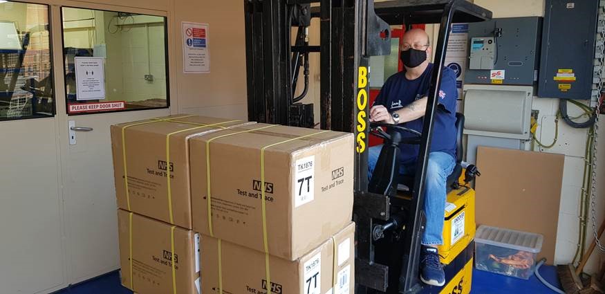 RH receiving delivery of NHS Test and Trace Kits on a pallet with fork lift