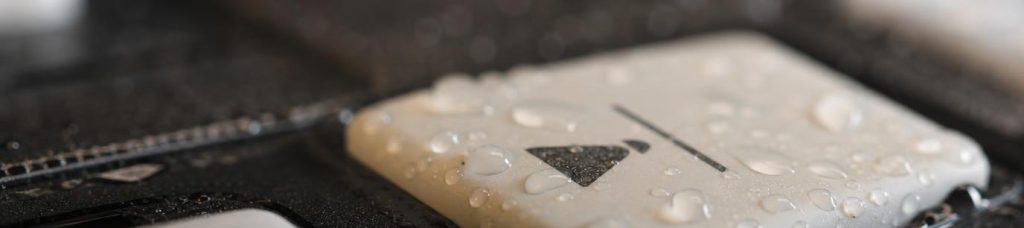 gpt-image-2_A_Photo_realistic_image_of_wet_droplets_on_a_control_panel_button._Macro_photogr-0